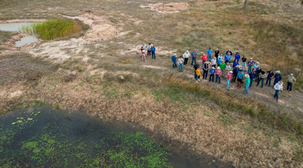 Sustainable Agriculture Facilitator Banner image of group of graziers out in a field, next to a swail and pond.